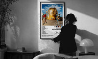 Travis Scott Astroworld Album Cover print in a slim black frame being hung on a sunlit wall in a monochrome room