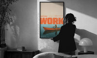 Slow Day at Work Gone Fishing print in a slim black frame being hung on a sunlit wall in a monochrome room