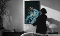Drake If You're Reading This It's Too Late print in a slim black frame being hung on a sunlit wall in a monochrome room