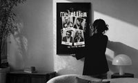 Metallica The Memory Remains Band Collage print in a slim black frame being hung on a sunlit wall in a monochrome room