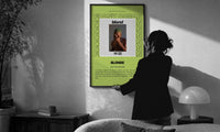 Frank Ocean Blonde Album Cover print in a slim black frame being hung on a sunlit wall in a monochrome room