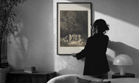 Dore Assembly of the Poets print in a slim black frame being hung on a sunlit wall in a monochrome room