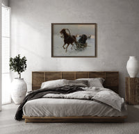 Horse pulling sleigh through snow print in a dark wood frame above a rattan bed on a plaster wall