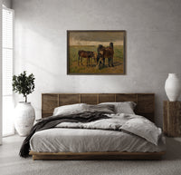 Group of horses in field print in a dark wood frame above a rattan bed on a plaster wall