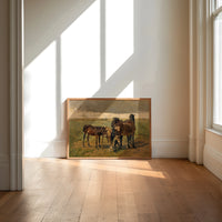 Group of horses in field print in an oak frame on a sunlit wood floor beneath tall window light