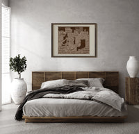 soldiers singing around a piano print in a dark wood frame above a rattan bed on a plaster wall