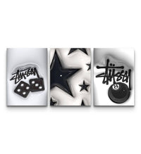 Three panel monochrome set with graffiti tag, inflated black stars, and a glossy 8 ball motif