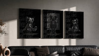 Black KAWS Companion Triptych in black frames on a grey wall above a leather sofa