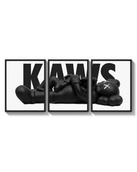 KAWS Monochrome Family Poster Set of 3 arranged on a bright gallery wall