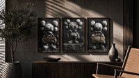 KAWS LV Monochrome Art Print Set of 3 in walnut frames above a sideboard in a warm room