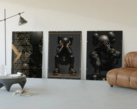 KAWS Noir XX Black Gold Poster Set of 3 displayed beside a brown leather sofa