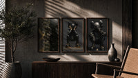 KAWS Noir XX Black Gold Poster Set of 3 in walnut frames above a sideboard in a warm room