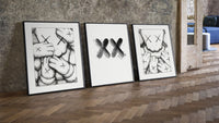 KAWS XX Outline Sketch Wall Art Set of 3 leaning on parquet beside a vintage loft door