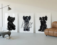 Blackout XX KAWS Hypebeast Wall Art Set of 3 displayed beside a brown leather sofa