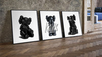 Blackout XX KAWS Hypebeast Wall Art Set of 3 leaning on parquet beside a vintage loft door