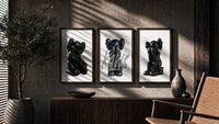 Blackout XX KAWS Hypebeast Wall Art Set of 3 in walnut frames above a sideboard in a warm room