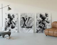 KAWS LV Monochrome Splash XX Wall Art Set of 3 displayed beside a brown leather sofa