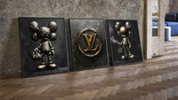 KAWS LV Gold Vault Poster Set of 3 leaning on parquet beside a vintage loft door