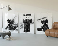 KAWS x Nike Blackout Poster Set of 3 displayed beside a brown leather sofa