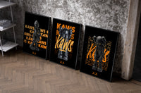 KAWS Signature Orange Edition set of three black-framed prints leaning against a raw-plaster wall