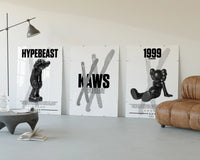 KAWS Black & White Classics three-panel set displayed beside a brown leather sofa