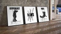 KAWS Black & White Classics three-piece set leaning on parquet beside a vintage loft door