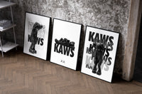 KAWS Legacy Archive set of three black-framed prints leaning against a raw-plaster wall