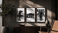 KAWS Legacy Archive triptych in three walnut frames above a sideboard in a warm room