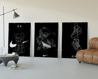KAWS Companion x Nike Swoosh Sketch Triptych displayed beside a brown leather sofa