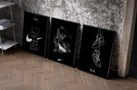 KAWS Companion x Nike Swoosh Sketch Triptych as black-framed prints leaning against a raw-plaster wall
