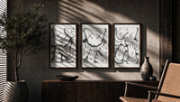KAWS XX Crosshatch Triptych in walnut frames above a sideboard in a warm room