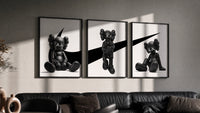 KAWS x Nike Monochrome Companion Triptych in black frames on a grey wall above a leather sofa