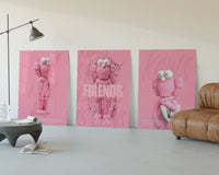 Pink Cotton Candy KAWS Friends Trio displayed beside a brown leather sofa