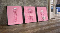 Pink Cotton Candy KAWS Friends Trio leaning on parquet beside a vintage loft door