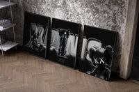 KAWS Neon Companions Triptych as black-framed prints leaning against a raw-plaster wall