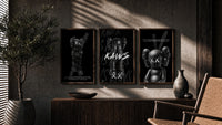 KAWS Companion Black Poster Set triptych in three walnut frames above a sideboard in a warm room