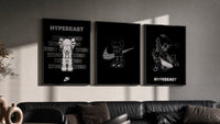 KAWS Hypebeast Poster Set triptych in three black frames on a grey wall above a leather sofa