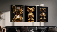 KAWS 24K Gold Figure Art Print Set of 3 in black frames on a grey wall above a leather sofa