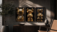 KAWS 24K Gold Figure Art Print Set of 3 in walnut frames above a sideboard in a warm room