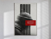 figure in helmet obscured by stripes poster in a slim frame on a bright wall with soft window light