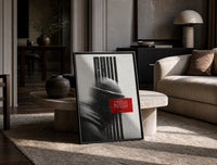 figure in helmet obscured by stripes print in a black frame leaning on a travertine table in a sunlit lounge