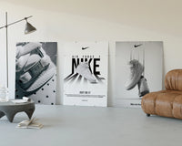 Nike AF1 White Triptych displayed beside a brown leather sofa