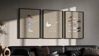 Off-White Nike Poster Set triptych in three black frames on a grey wall above a leather sofa