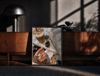 Black-framed Iced Coffee with Sunglasses and Handbag print on the floor in front of a dark wooden console