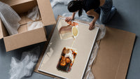 Iced Latte Cream Pour framed print being unpacked from protective bubble wrap and a box