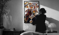 Iridescent Flowers Over the Face print in a slim black frame being hung on a sunlit wall in a monochrome room
