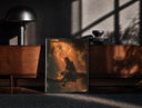 Black-framed Anime ninja sitting on tree branch print on a moody console with designer coffee-table books