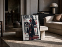 Itachi Uchiha anime character print in a black frame leaning on a travertine table in a sunlit lounge