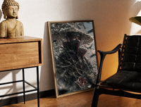 Brass-framed anime ninja with red eyes print leaning in a warm styled corner by a sculpture