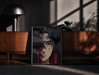 Black-framed Anime ninja with red Sharingan eye print on a moody console with designer coffee-table books